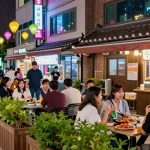 Enjoying 상봉동 한국관나이트 with friends, traditional snacks and drinks creating a vibrant nightlife scene.